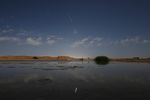 2025 August 15

Moonlight, Planets, and Perseids
 * Image Credit & Copyright: Jeff Dai (TWAN)

Explanation: 
In the predawn sky on August 13, two planets were close. And despite the glare of a waning gibbous Moon, bright Jupiter and even brighter Venus were hard to miss. Their brilliant close conjunction is posing above the eastern horizon in this early morning skyscape. The scene was captured in a single exposure from a site near Gansu, China, with light from both planets reflected in the still waters of a local pond. Also seen against the moonlight were flashes from the annual Perseid Meteor Shower, known for its bright, fast meteors. Near the much anticipated peak of activity, the shower meteors briefly combined with the two planets for a celestial spectacle even in moonlit skies. 


Authors & editors: Robert Nemiroff (MTU) & Jerry Bonnell (UMCP)
NASA Official: Amber Straughn Specific rights apply.
NASA Web Privacy, Accessibility, Notices;
A service of: ASD at NASA / GSFC,
NASA Science Activation
& Michigan Tech. U.
