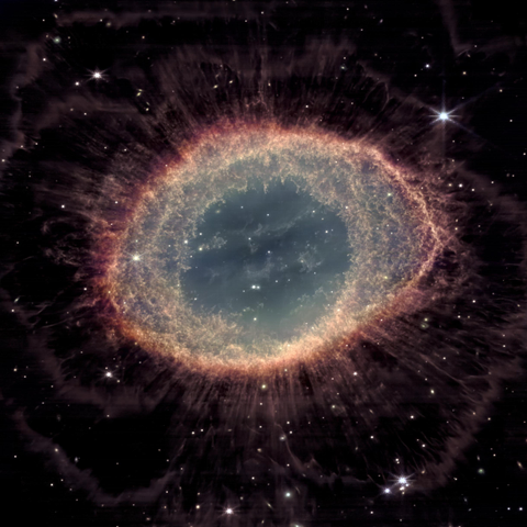 A glowing, circular nebula with a bright, textured outer ring that fades into a dark background filled with stars. The center of the ring is a smooth, teal-blue area with faint, cloudy structures and small bright points. The ring itself appears reddish-orange with intricate filaments extending outward like wispy tendrils. Surrounding the nebula, the dark space is scattered with bright white stars, some with distinct diffraction spikes.