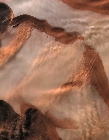 Animation of a dust storm over Mars' north polar cap, showing swirling shades of red, brown, and the white of the polar ice. The dust appears to move southward in filament-shaped clouds.