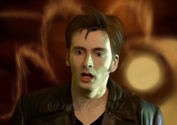 david tennant as the tenth doctor, just after the ninth doctor's regeneration, with the golden light still glowing around him